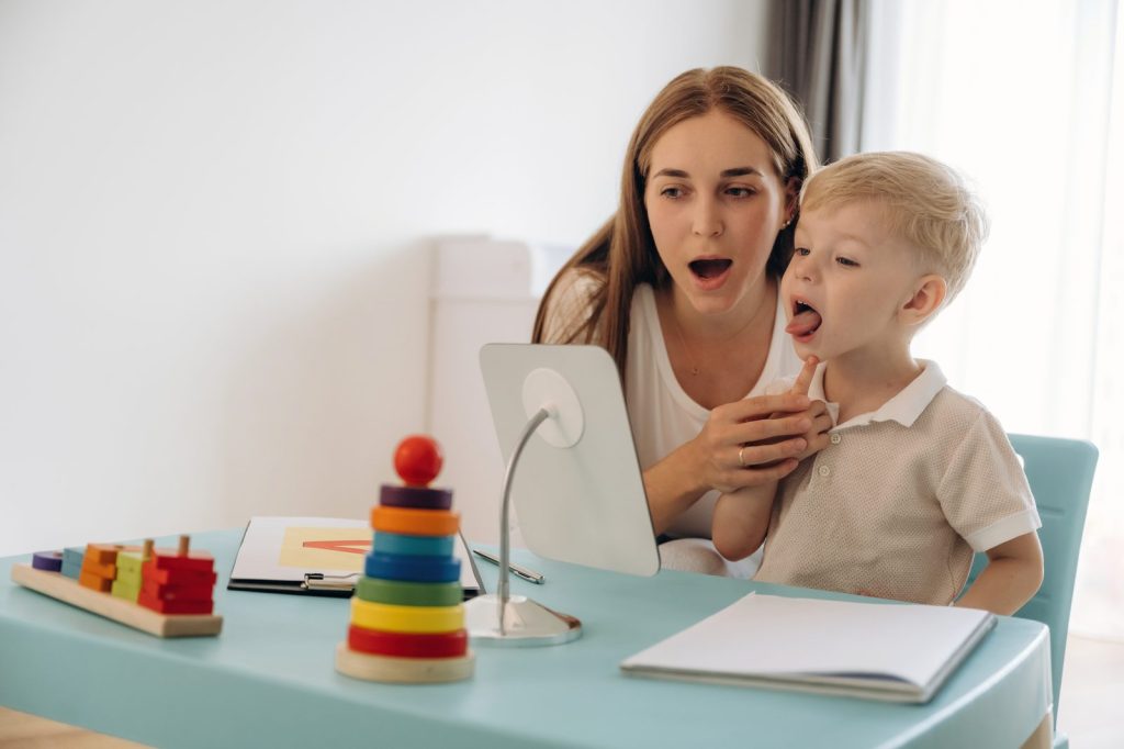 A therapist demonstrating letter pronunciation