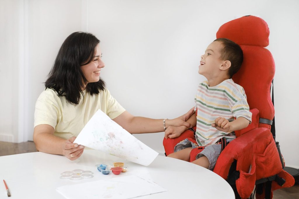 A specialist painting with a child with special needs