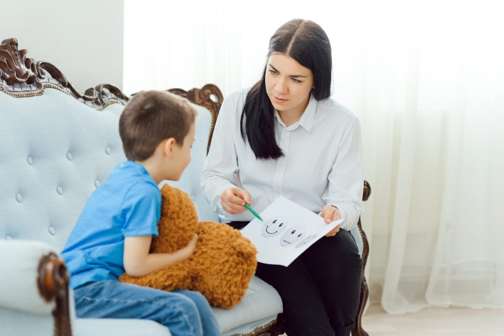 A specialist talking with a boy about his feelings