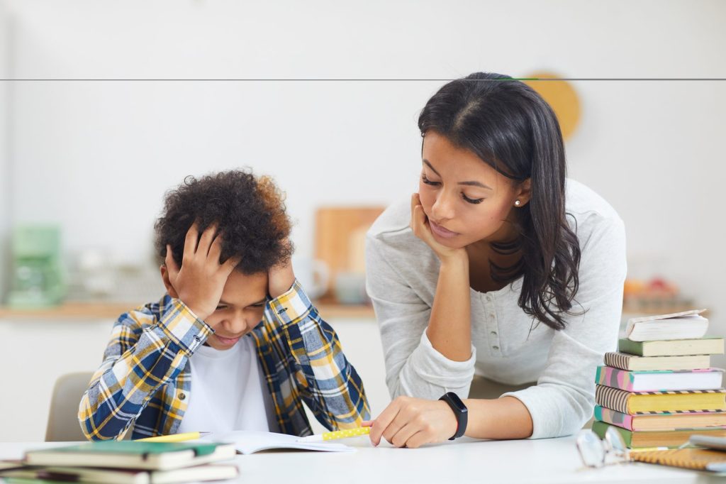 A boy struggling with a school task
