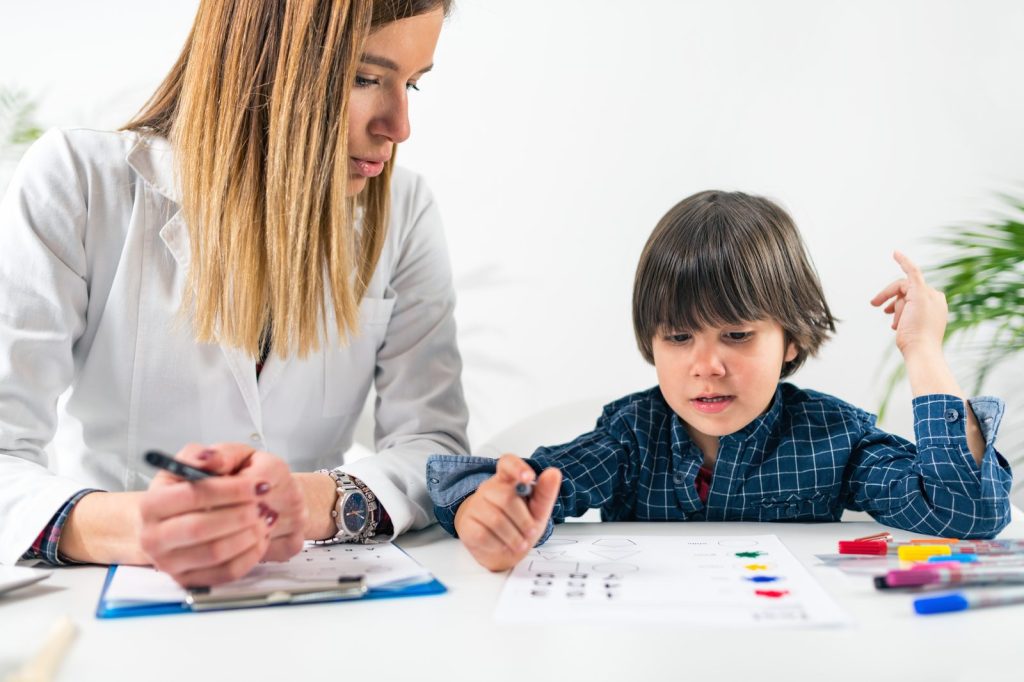 A child drawing with a specialist during evaluation